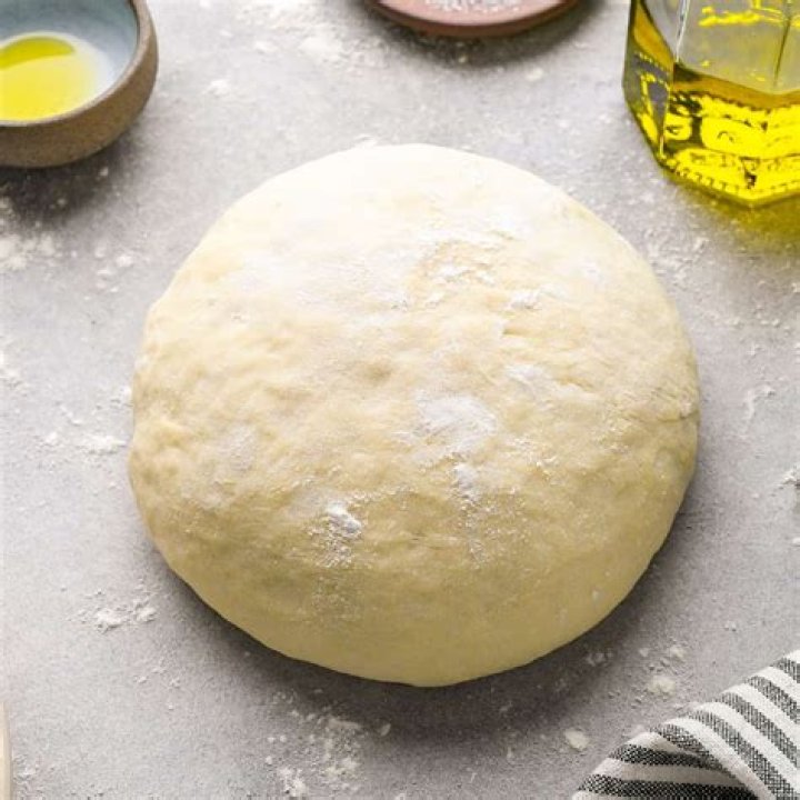 What does adding olive oil to pizza dough do?